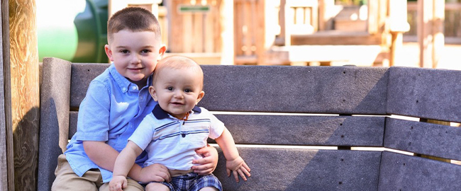Collin Kirk and Hunter Kirk sitting on a bench