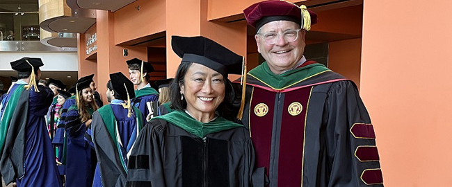 Two people in graduation cap and gowns