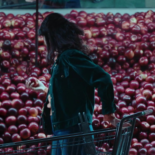 Woman standing in front of fruit