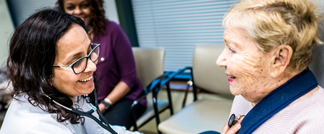Female doctor with elderly patient