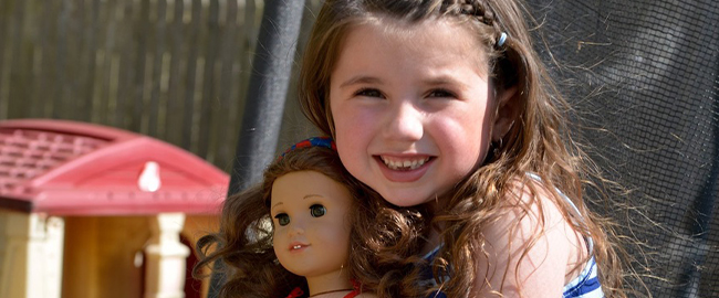 Olivia Covino holding an American Girl doll
