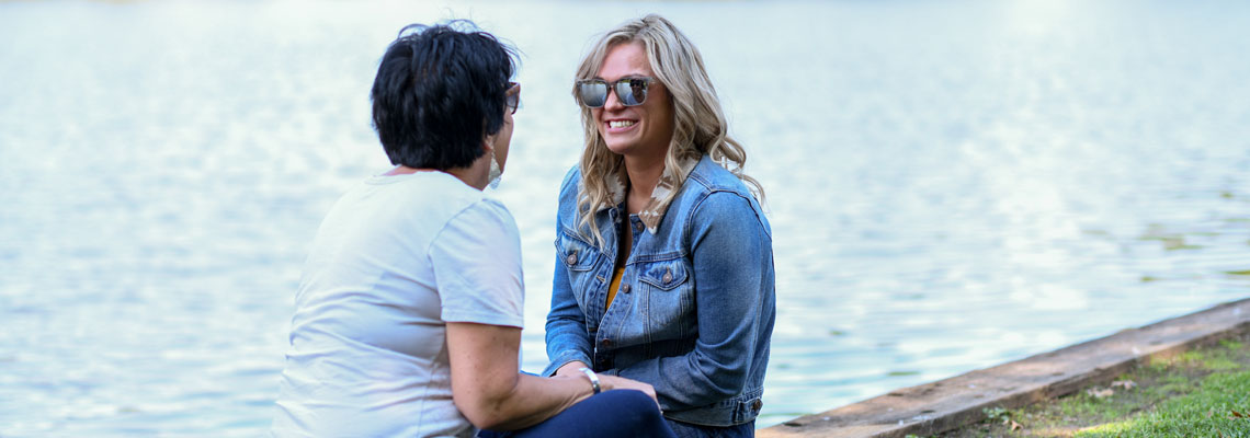 Women speaking near water