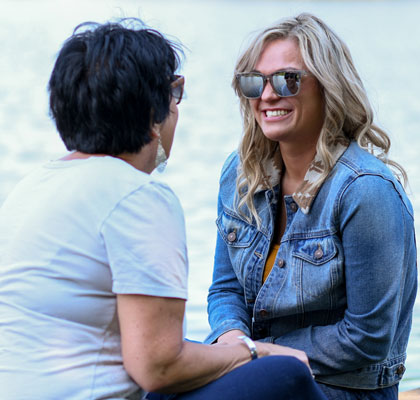 Women speaking near water