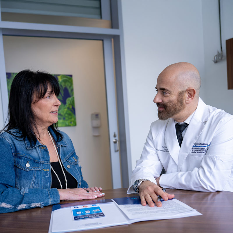 Doctor reviewing paperwork with a patient during an in-office consultation at a healthcare clinic.