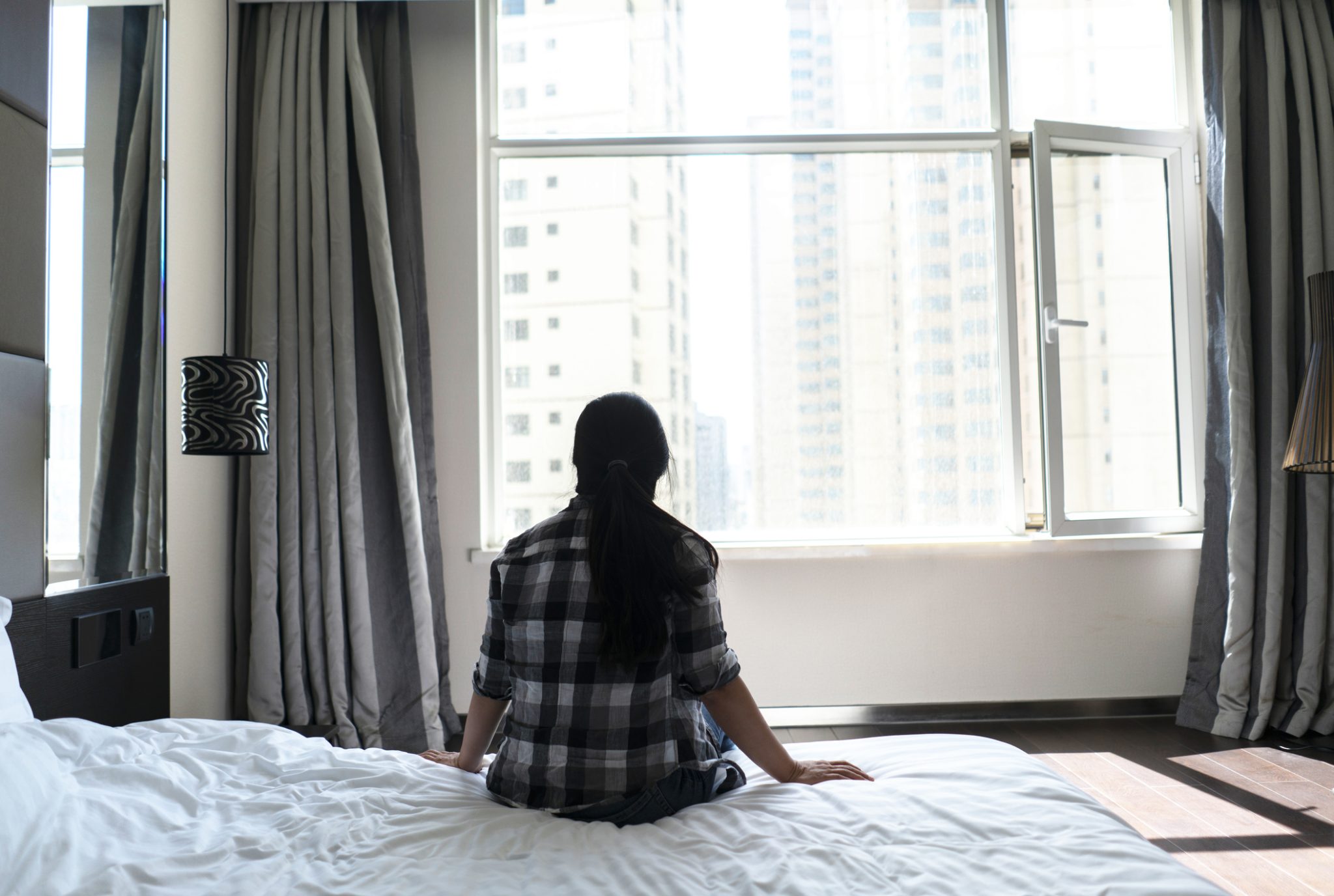 Sitting on bed looking out window