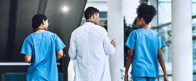 NJ hospital healthcare team walking in modern, bright medical facility