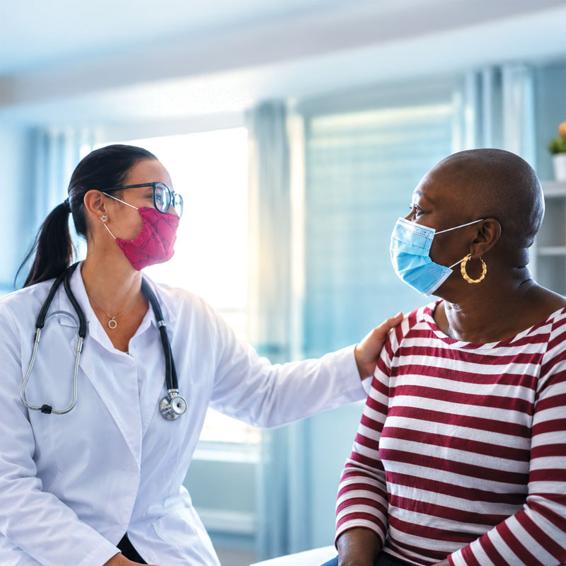 Doctor comforting a patient during a medical visit.
