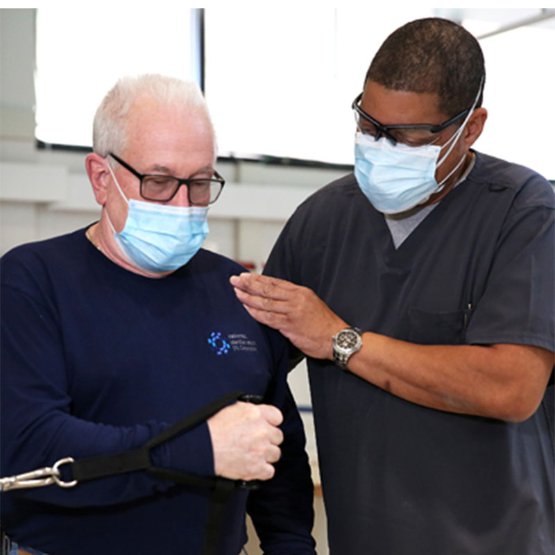 Orthopedics specialist and patient doing shoulder rehab