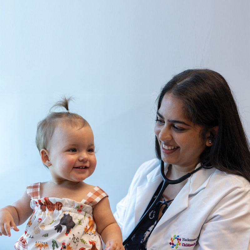 Pediatrician caring for young child