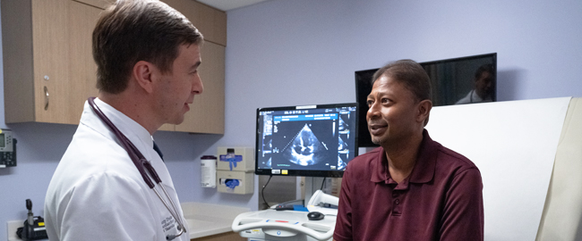 physician and patient talking in exam room