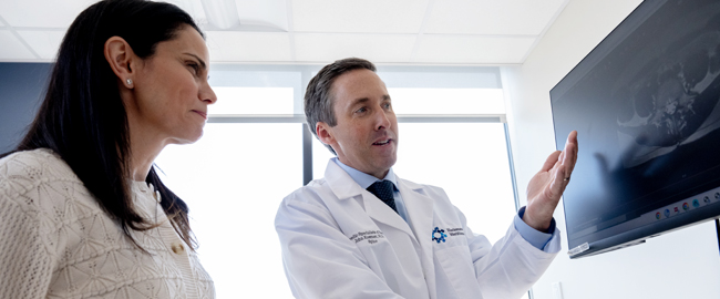 back spine expert physician talking to patient