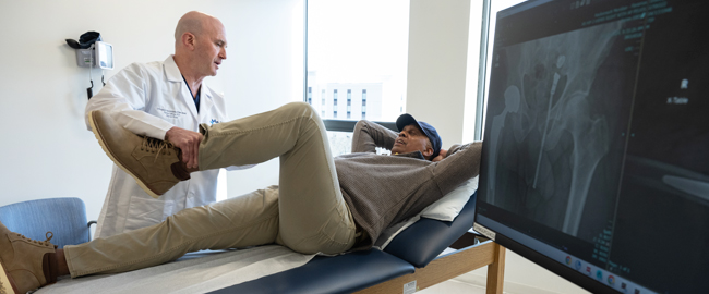 physician bending patients knee