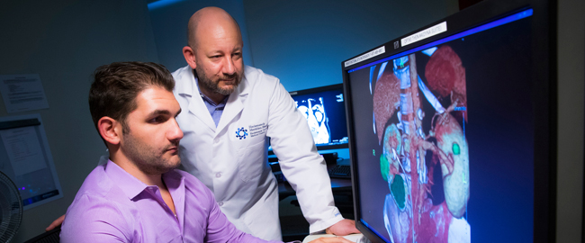 Urology physicians reviewing a scan