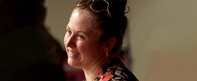 Woman smiling with glasses on top of her head