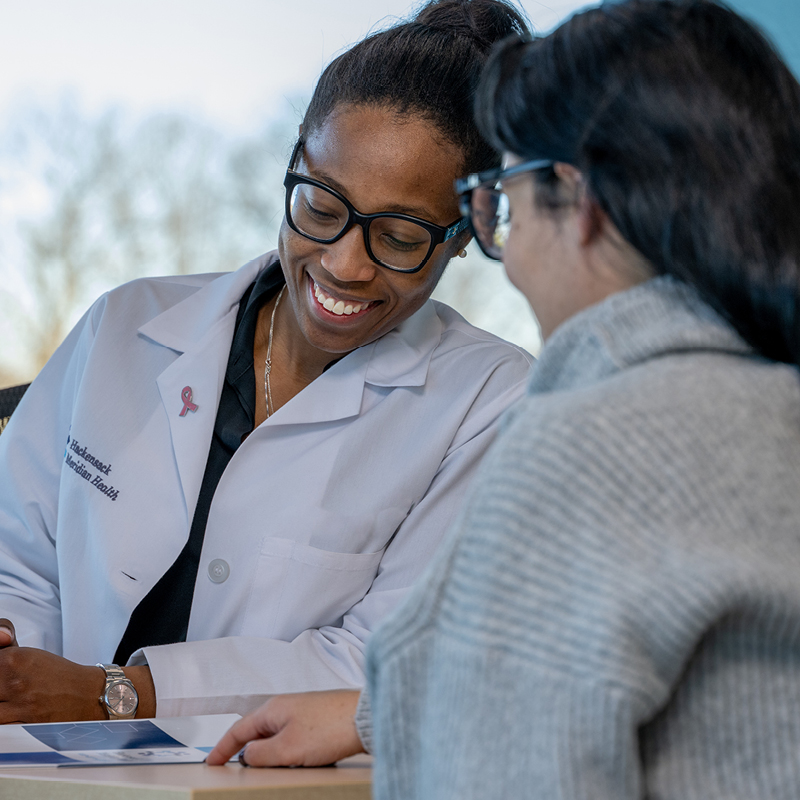 Healthcare professional reviewing information with a patient.