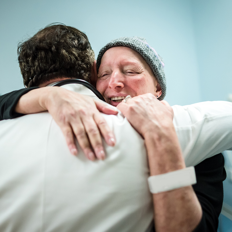 Patient embracing a healthcare professional.