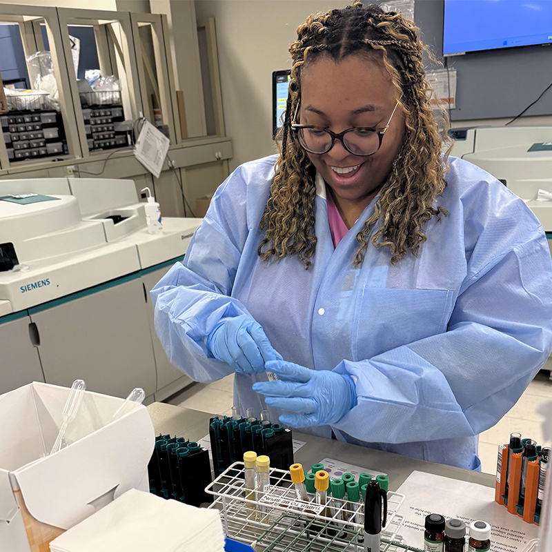 Female student  wearing protective gear in the lab.