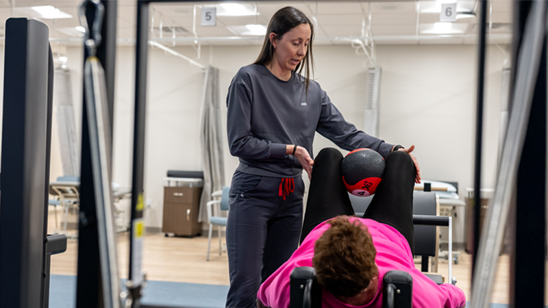 Nurse rehabbing with patient