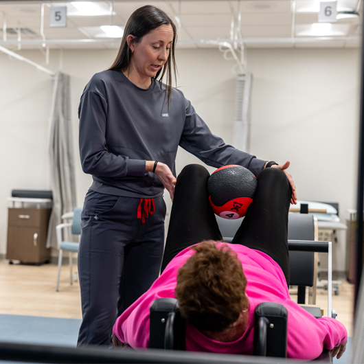 Nurse rehabbing with patient