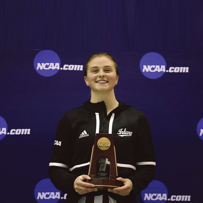 Olympic Diver holding NCAA award