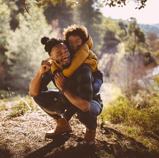 young african american male with son on back