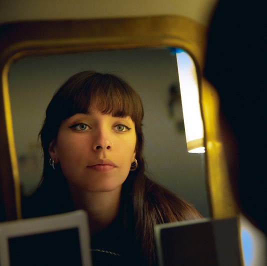 young beautiful woman looking in the mirror