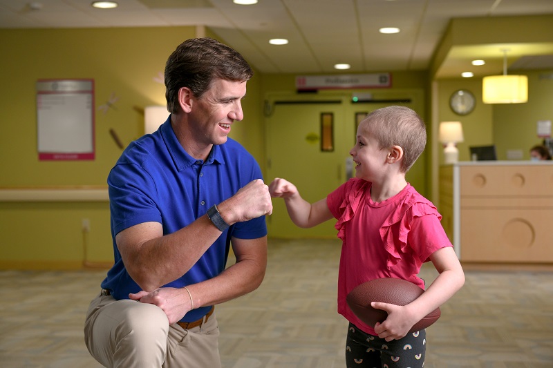 child and provider fist bumping