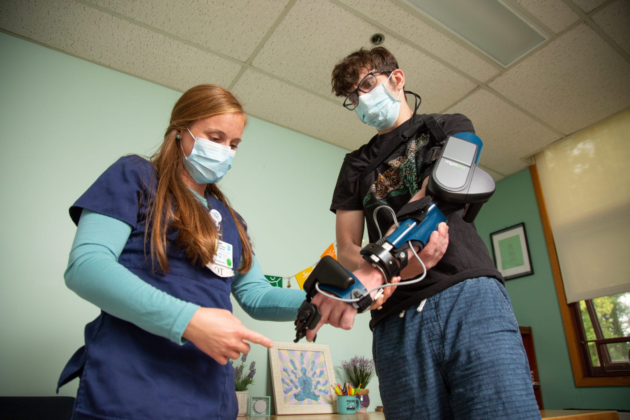 Female nurse with maile patient using arm technology