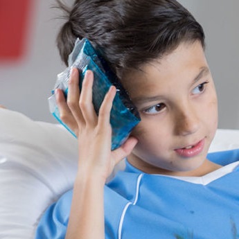 Young boy with icepack on head