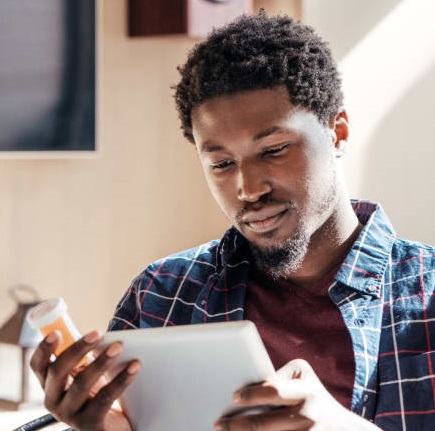 Young man reading medication information