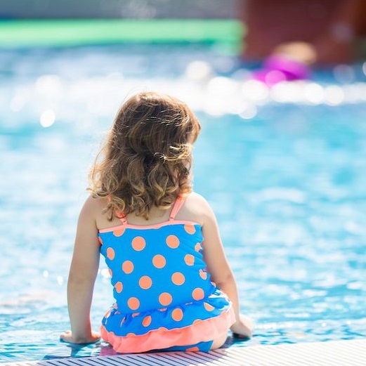 girl sitting by pool