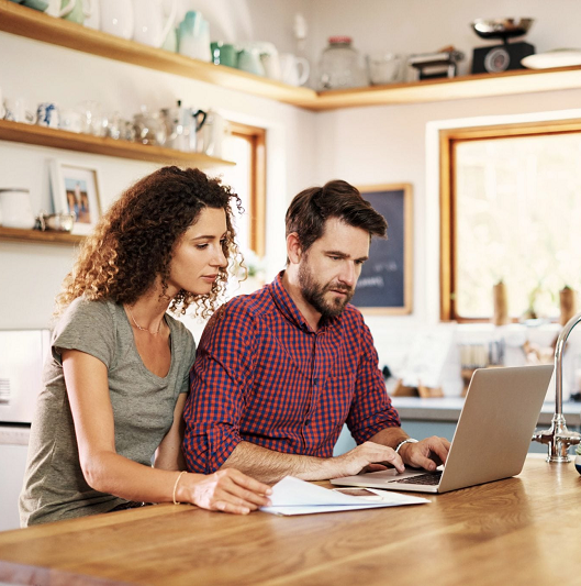 Family makes an emergency preparedness plan on their laptop.