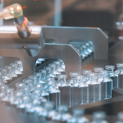 Glass bottles in production in the tray of an automatic liquid dispenser, a line for filling medicines against bacteria and viruses, antibiotics and vaccines.