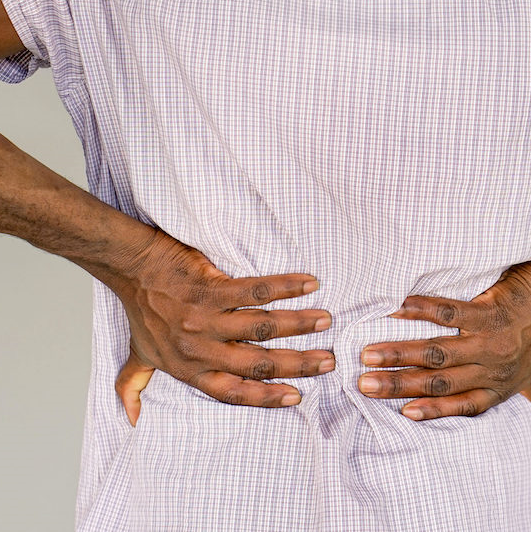person clenching lower back from back pain