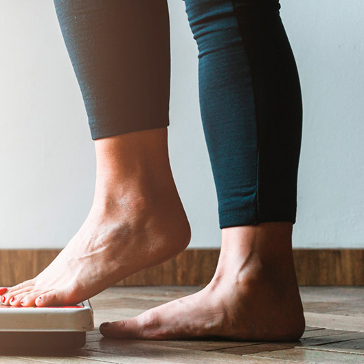 Person stepping onto scale