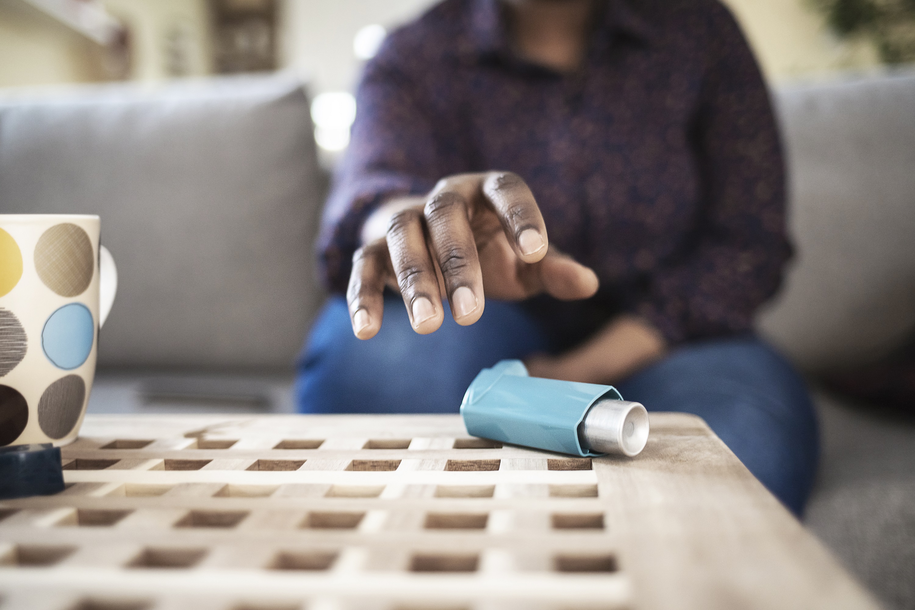 Man reaching for inhaler