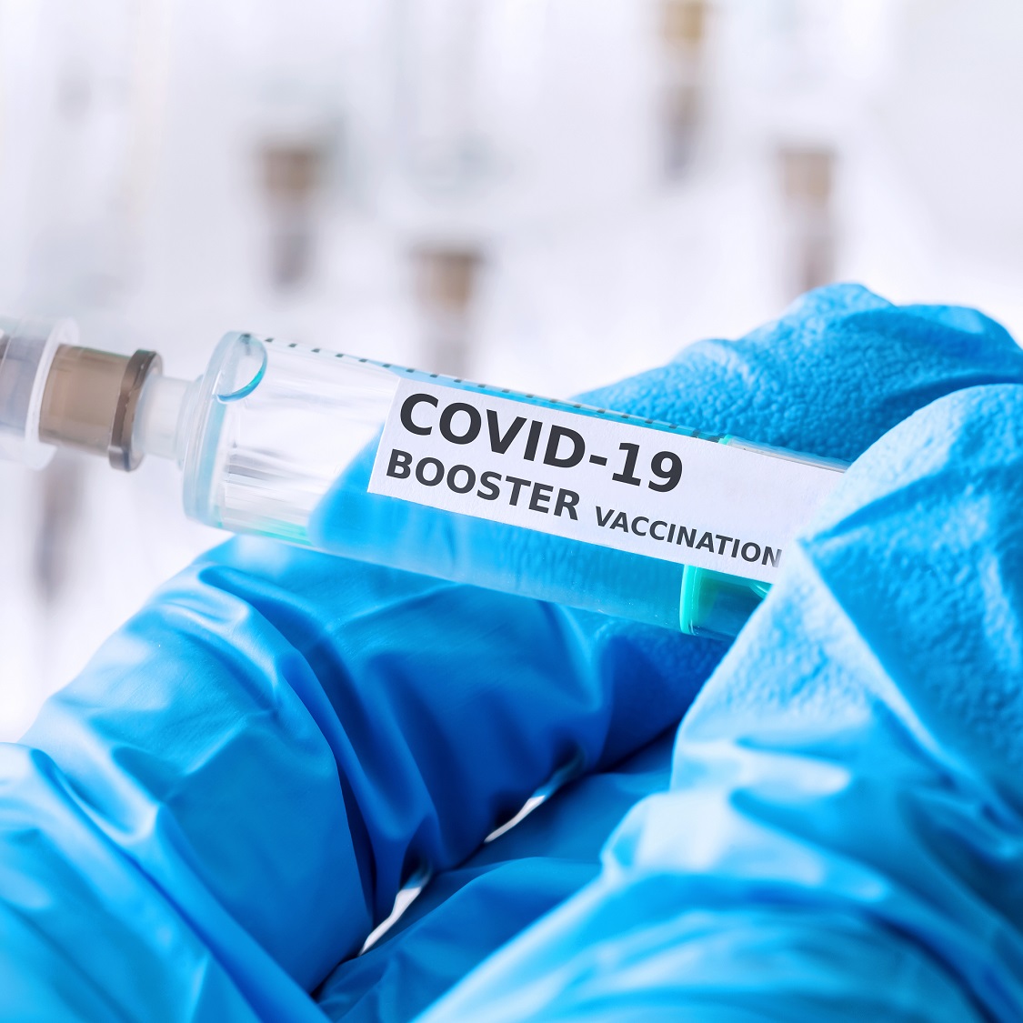 hand holding COVID shot