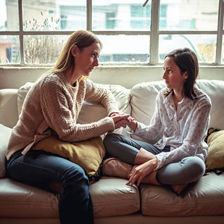 mother talking with teenage daughter 