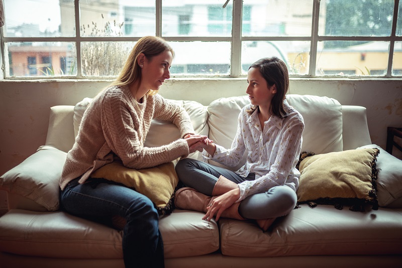mother talking with teenage daughter