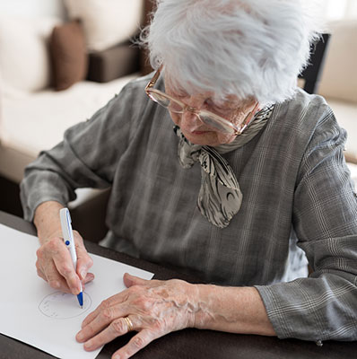 High angle view of a senior Caucasian woman doing Alzheimer's disease cognitive functions assessment test