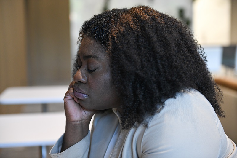 Young woman tired, experiencing brain fog due to long COVID.