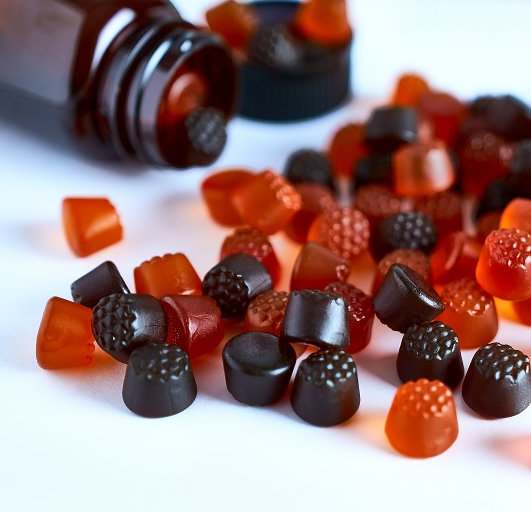 Multivitamins spread out over on a counter.