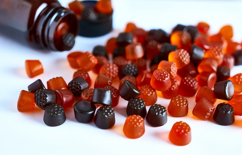 Multivitamins spread out over on a counter.