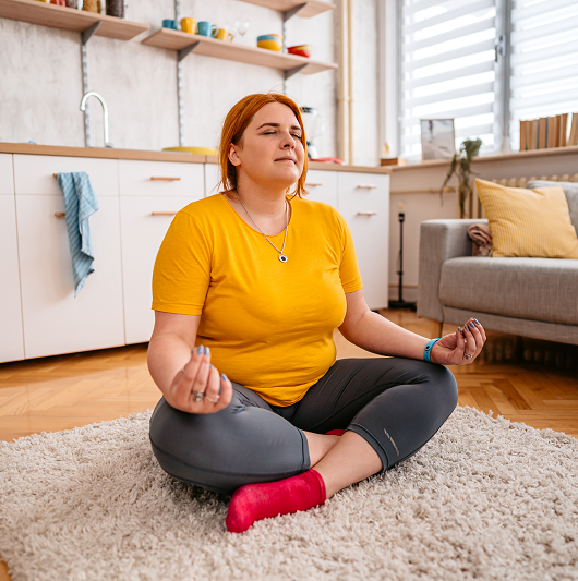 Young woman after weight loss surgery meditating and working out. 