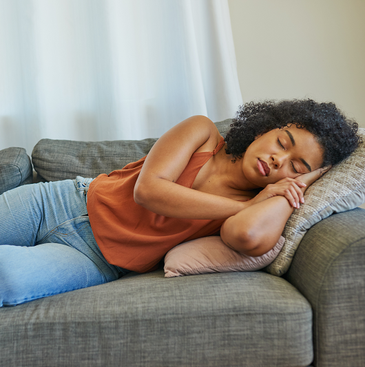 Young woman taking a nap on the couch.