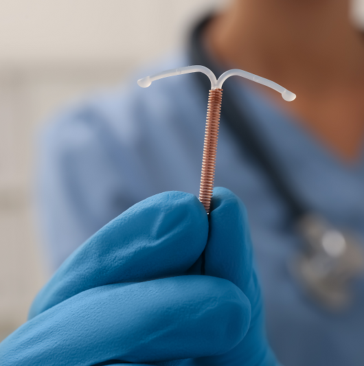 Physician holding an IUD with gloves on. Pregnancy contraception.