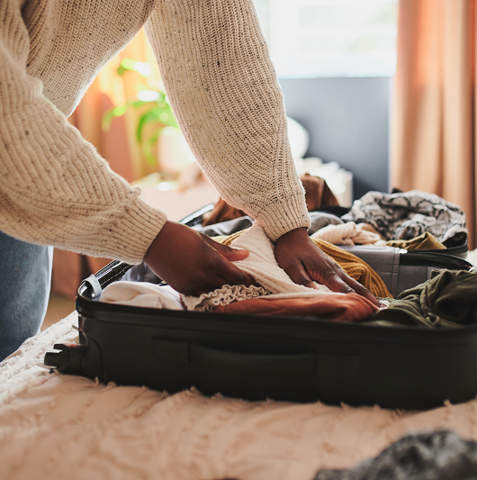 woman packing her things into a bag at home before a surgical stay; what to pack before surgery