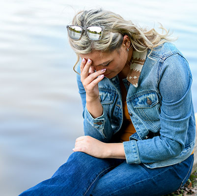 Young woman dealing with the mental health impact of long COVID; sad and anxious