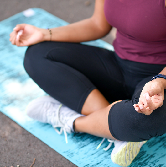 Young woman enjoying meditation outside.