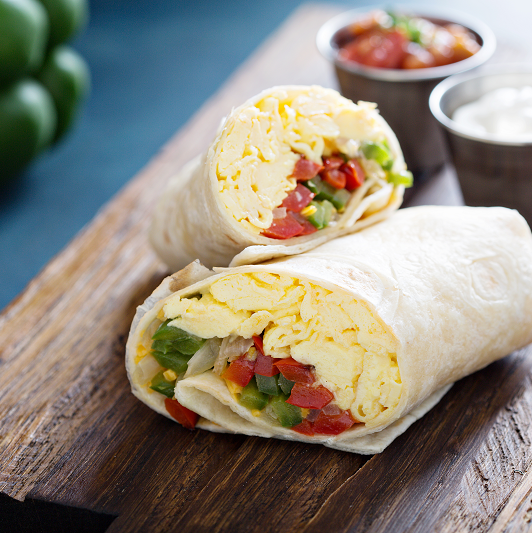 Breakfast burrito with eggs and salsa.